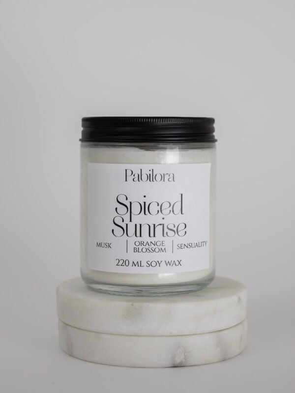 Pabilora Spiced Sunrise scented candle blending orange blossom, Moroccan spices, fruity mandarin tea, and a seductive musk finish.